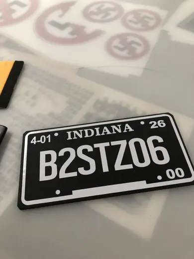 Custom black novelty license plate on a table