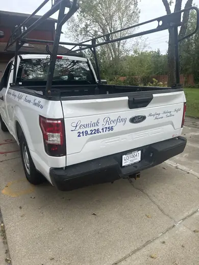 White pickup with lettering on the tailgate area